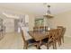 Dining room with a large wooden table, 6 chairs, and a modern chandelier at 4155 Center Gate Blvd, Sarasota, FL 34233