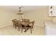 Dining room with a large table, seating for eight, and modern lighting fixture at 4155 Center Gate Blvd, Sarasota, FL 34233