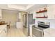 Bright kitchen with stainless steel appliances, ample cabinet space, and tile flooring at 4155 Center Gate Blvd, Sarasota, FL 34233