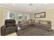 Spacious living room with comfortable seating, a modern rug, and views of the outdoors at 4155 Center Gate Blvd, Sarasota, FL 34233