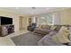Bright living room featuring a large sectional sofa and abundant natural light from large windows at 4155 Center Gate Blvd, Sarasota, FL 34233