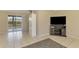 Comfortable living room with tiled flooring, a large television, and access to the outdoors at 4155 Center Gate Blvd, Sarasota, FL 34233