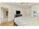 Primary bedroom featuring neutral decor, ceiling fan, and dresser with a television at 4155 Center Gate Blvd, Sarasota, FL 34233
