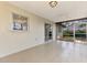 A cozy, covered patio with tile flooring, window, and sliding glass door at 4155 Center Gate Blvd, Sarasota, FL 34233