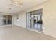 Covered patio with tile flooring and access to the home's interior via sliding glass doors at 4155 Center Gate Blvd, Sarasota, FL 34233