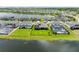 Aerial view of beautiful homes next to a lake, surrounded by lush greenery and a neighborhood at 4430 Pond Brook Ct, Bradenton, FL 34211