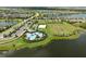 Aerial view of the community pool, sports fields, and surrounding homes and ponds at 4430 Pond Brook Ct, Bradenton, FL 34211