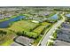 Beautiful aerial community view featuring lakes, community pool, sport courts, playground, and manicured lawns at 4430 Pond Brook Ct, Bradenton, FL 34211
