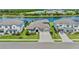 Aerial view of a beautiful home next to a lake and golf course surrounded by lush greenery at 4430 Pond Brook Ct, Bradenton, FL 34211