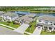 Aerial view of a beautiful home next to a lake and golf course surrounded by lush greenery at 4430 Pond Brook Ct, Bradenton, FL 34211