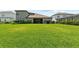 Spacious backyard features ample green space with exterior view of the home at 4430 Pond Brook Ct, Bradenton, FL 34211