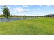 Expansive backyard offers lush green grass, a lake view, and a secure fence at 4430 Pond Brook Ct, Bradenton, FL 34211