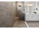 Elegant bathroom features a tiled walk-in shower with a built-in bench and a modern vanity at 4430 Pond Brook Ct, Bradenton, FL 34211