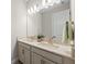 Bright bathroom featuring a double vanity with granite countertop and modern fixtures at 4430 Pond Brook Ct, Bradenton, FL 34211