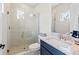 Well-lit bathroom featuring a glass enclosed shower, attractive tiling, and a vanity with a granite countertop at 4430 Pond Brook Ct, Bradenton, FL 34211