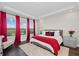 Bright main bedroom features a trey ceiling, plush rug, large windows, and modern furnishings at 4430 Pond Brook Ct, Bradenton, FL 34211