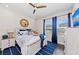 Nautical-themed bedroom with a ceiling fan, dark wood floors, and lots of natural light at 4430 Pond Brook Ct, Bradenton, FL 34211
