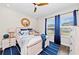 Bright bedroom featuring coastal decor, ceiling fan, hardwood floors, and lots of natural light at 4430 Pond Brook Ct, Bradenton, FL 34211