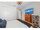 Well-lit bedroom featuring a closet, mounted TV, and wooden dresser with toys at 4430 Pond Brook Ct, Bradenton, FL 34211