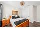 Well-lit bedroom featuring a wooden bed frame, closet, and bedside table with lamp at 4430 Pond Brook Ct, Bradenton, FL 34211