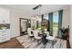 Elegant dining room featuring a modern table, stylish chairs, a large mirror, and chic decor at 4430 Pond Brook Ct, Bradenton, FL 34211