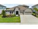 Charming single-Gathering home featuring a stone facade, well-manicured lawn, and a two-car garage at 4430 Pond Brook Ct, Bradenton, FL 34211