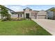 Charming single-Gathering home featuring a stone facade, well-manicured lawn, and a two-car garage at 4430 Pond Brook Ct, Bradenton, FL 34211