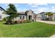 Charming single-Gathering home featuring a stone facade, well-manicured lawn, and a two-car garage at 4430 Pond Brook Ct, Bradenton, FL 34211