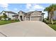 Charming single-Gathering home featuring a stone facade, well-manicured lawn, and a two-car garage at 4430 Pond Brook Ct, Bradenton, FL 34211