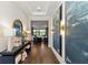 Elegant hallway with hardwood floors, console table, stylish decor, and entry to the living room at 4430 Pond Brook Ct, Bradenton, FL 34211