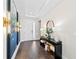 Inviting hallway with hardwood floors, stylish decor, a console table and leading to the entrance at 4430 Pond Brook Ct, Bradenton, FL 34211