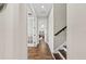 Hallway boasts hardwood floors leading to the bedrooms, with a staircase and natural light enhancing the space at 4430 Pond Brook Ct, Bradenton, FL 34211