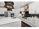 Clean modern kitchen with white cabinets, stainless steel appliances, and a large island providing ample workspace at 4430 Pond Brook Ct, Bradenton, FL 34211