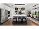 Contemporary kitchen boasts stainless appliances, a large center island with seating, and elegant pendant lighting at 4430 Pond Brook Ct, Bradenton, FL 34211