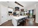 Modern kitchen featuring a large island, stainless steel appliances, and stylish pendant lighting over an adjacent dining area at 4430 Pond Brook Ct, Bradenton, FL 34211