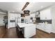 Well-appointed kitchen with a spacious island, sleek white cabinetry, stainless appliances, and elegant pendant lighting at 4430 Pond Brook Ct, Bradenton, FL 34211