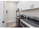 Functional laundry room equipped with modern washer/dryer and ample storage cabinets at 4430 Pond Brook Ct, Bradenton, FL 34211
