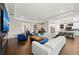Open-concept living room with hardwood floors, modern fireplace, comfortable seating, and connected kitchen at 4430 Pond Brook Ct, Bradenton, FL 34211