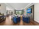 Bright living room with hardwood floors, modern fireplace, comfortable seating, and sliding doors with view at 4430 Pond Brook Ct, Bradenton, FL 34211