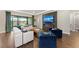 Bright living room with hardwood floors, modern fireplace, comfortable seating, and sliding doors with view at 4430 Pond Brook Ct, Bradenton, FL 34211