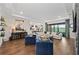 Spacious living room with hardwood floors, comfortable seating, modern fireplace, and open to kitchen at 4430 Pond Brook Ct, Bradenton, FL 34211