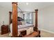 Elegant main bedroom with a four-poster bed, neutral color palette, and natural light at 4430 Pond Brook Ct, Bradenton, FL 34211