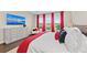 Main bedroom features a dresser with television, large windows showcasing a beautiful view with red curtains at 4430 Pond Brook Ct, Bradenton, FL 34211
