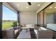 Relaxing screened patio with comfortable seating and a beautiful view of the lake at 4430 Pond Brook Ct, Bradenton, FL 34211