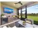 Relaxing sunroom features a flat screen television, wet bar, and stunning water view at 4430 Pond Brook Ct, Bradenton, FL 34211