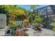 Charming backyard featuring a wooden swing, brick pavers, and a variety of colorful potted plants at 4612 4Th E Ave, Bradenton, FL 34208