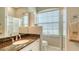 Bathroom featuring a granite vanity, a mirror, and a glass shower with natural light at 4612 4Th E Ave, Bradenton, FL 34208