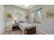Cozy bedroom featuring a comfortable bed, natural light, and decorative artwork at 4612 4Th E Ave, Bradenton, FL 34208