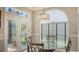Inviting breakfast nook with a glass table, chandelier, and access to the patio at 4612 4Th E Ave, Bradenton, FL 34208