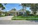 Charming single-story home featuring a well-manicured lawn, lush landscaping, and a welcoming facade at 4612 4Th E Ave, Bradenton, FL 34208